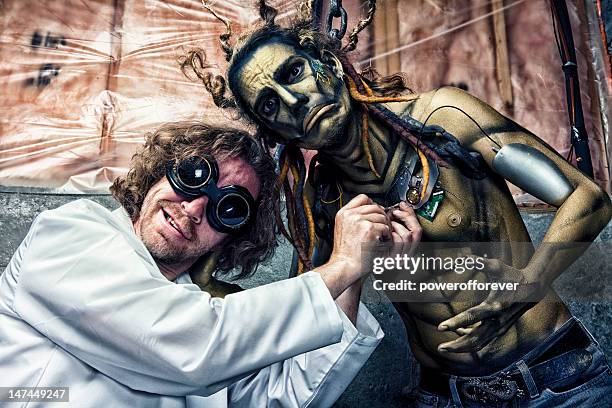 scientist working on his robot - mad scientist stock pictures, royalty-free photos & images