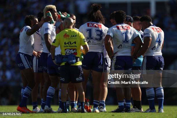 Bulldogs players take on water during a drinks break during the round three NRL match between Canterbury Bulldogs and Wests Tigers at Belmore Sports...