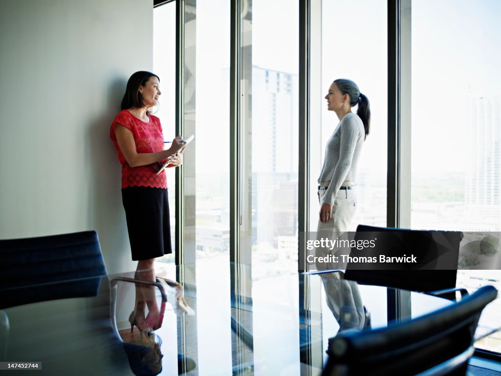 Coworkers standing in office in discussion