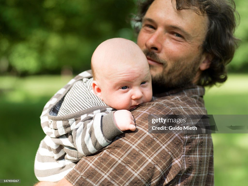 Father carrying baby on shoulder