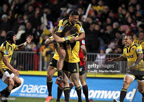 Hurricanes team mates celebrate after the round 16 Super Rugby match between the Crusaders and the Hurricanes at AMI Stadium on June 30, 2012 in...