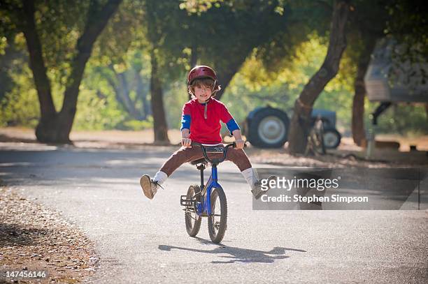 novice bicycle rider trying new tricks - bicycle stunt stock pictures, royalty-free photos & images