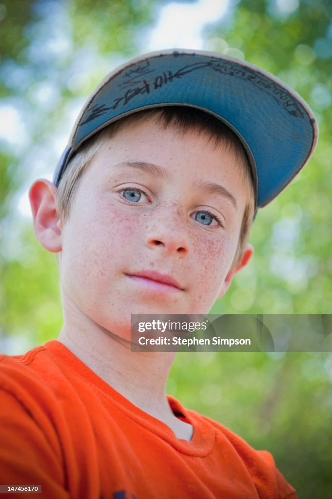Outdoor portrait of freckled boy, nine years old