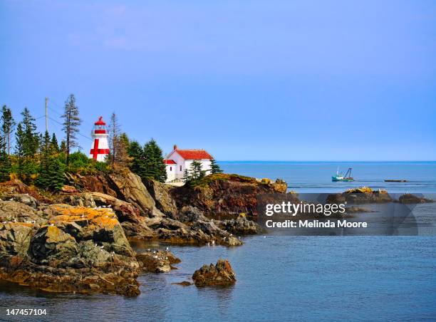 east quoddy lighthouse with boat - new brunswick canada stock pictures, royalty-free photos & images