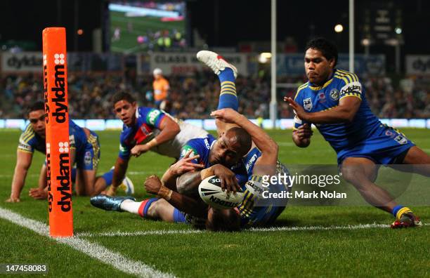Akuila Uate of the Knights scores during the round 17 NRL match between the Parramatta Eels and the Newcastle Knights at Parramatta Stadium on June...