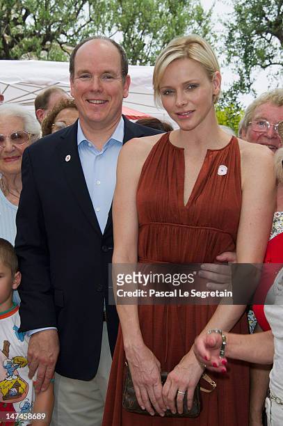 Prince Albert II of Monaco and Princess Charlene attend the annual Monaco Red Cross Pique-Nique at Jardins Princesse Antoinette on June 30, 2012 in...