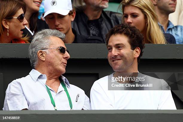 Actor Dustin Hoffman and tennis player Justin Gimelstob attend the Ladies' Singles third round match Serena Williams of the USA and Jie Zheng of...