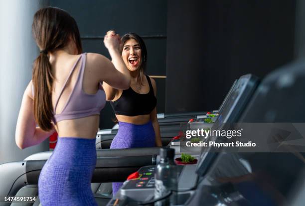 beautiful women exercising at the gym running on a treadmill - protein shaker stock pictures, royalty-free photos & images