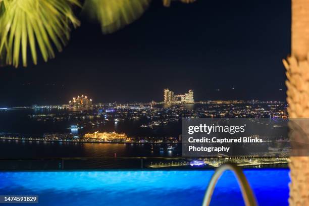 night view of dubai palm jumeirah islands skyline from the world's highest infinity pool - dubai skyscraper stock pictures, royalty-free photos & images