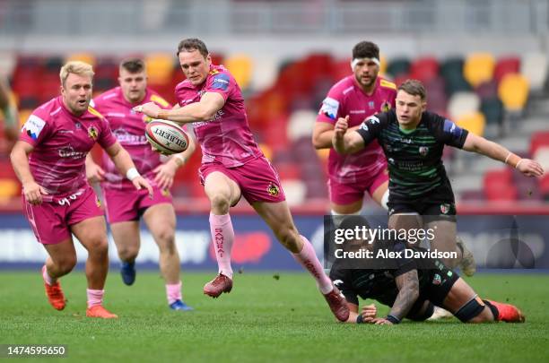 Tom Wyatt of Exeter Chiefs evades the tackle of So'otala Fa'aso'o of London Irish during the Premiership Rugby Cup match between London Irish and...