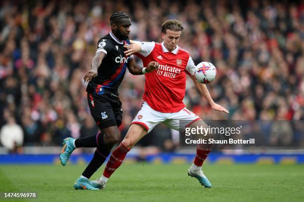 Rob Holding of Arsenal is challenged by Odsonne Edouard of Crystal Palace during the Premier League match between Arsenal FC and Crystal Palace at...