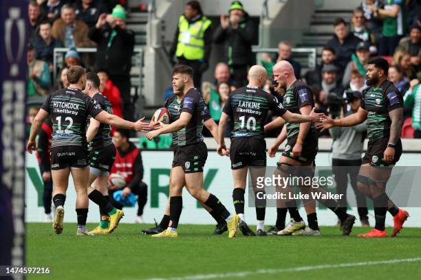 Ignacio Ruiz of London Irish celebrates scoring their side's first try with teammates during the Premiership Rugby Cup match between London Irish and...