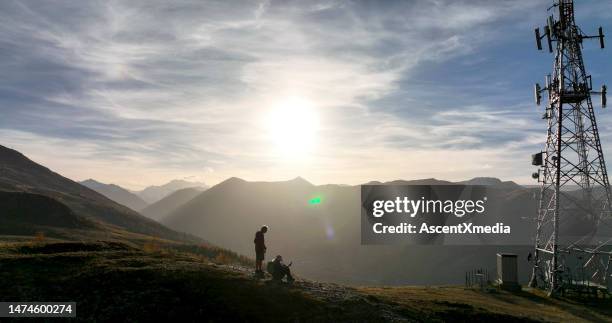 senior couple on hill at sunrise - communications tower stock pictures, royalty-free photos & images