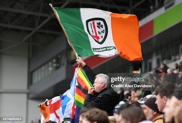 Fan of London Irish waves an Irish flag during the Premiership Rugby Cup match between London Irish and Exeter Chiefs at Gtech Community Stadium on...