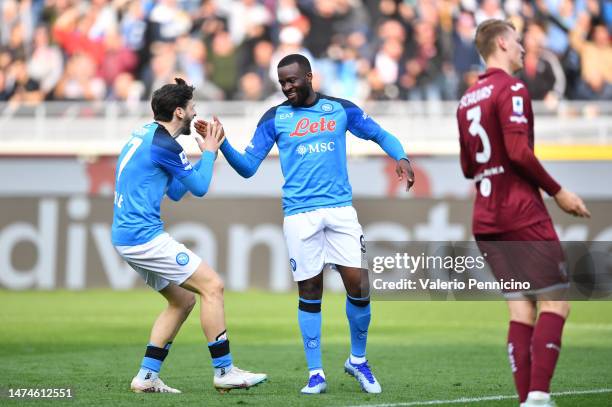 Tanguy NDombele of SSC Napoli celebrates with teammate Khvicha Kvaratskhelia after scoring the team's fourth goal during the Serie A match between...