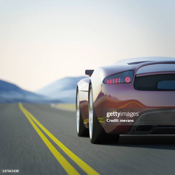 red sports car in a road through the mountains - prestige car stock pictures, royalty-free photos & images