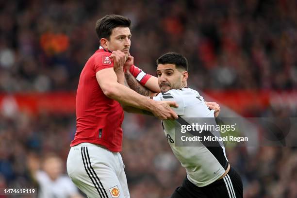 Aleksandar Mitrovic of Fulham battles for possession with Harry Maguire of Manchester United during the Emirates FA Cup Quarter Final match between...