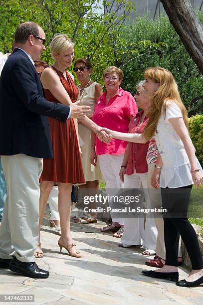 Prince Albert II of Monaco and Princess Charlene attend the annual Monaco Red Cross Pique-Nique at Jardins Princesse Antoinette on June 30, 2012 in...