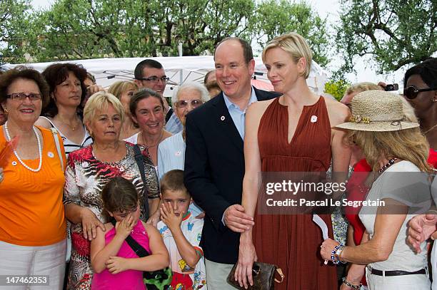 Prince Albert II of Monaco and Princess Charlene attend the annual Monaco Red Cross Pique-Nique at Jardins Princesse Antoinette on June 30, 2012 in...