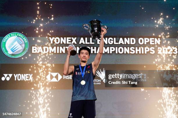 Li Shifeng of China poses with his trophy on the podium after the Men's Single Final match against Shi Yuqi of China on day six of the Yonex All...