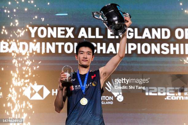 Li Shifeng of China poses with his trophy on the podium after the Men's Single Final match against Shi Yuqi of China on day six of the Yonex All...