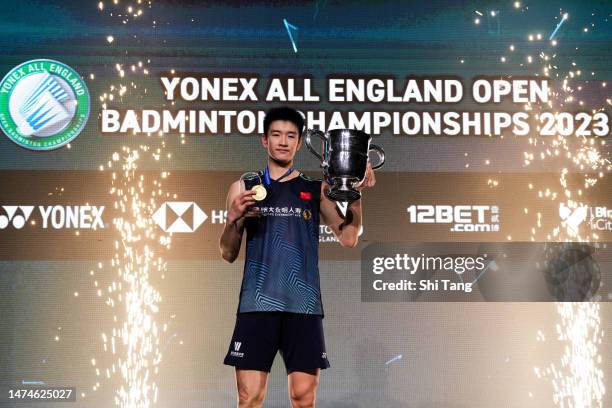 Li Shifeng of China poses with his trophy on the podium after the Men's Single Final match against Shi Yuqi of China on day six of the Yonex All...