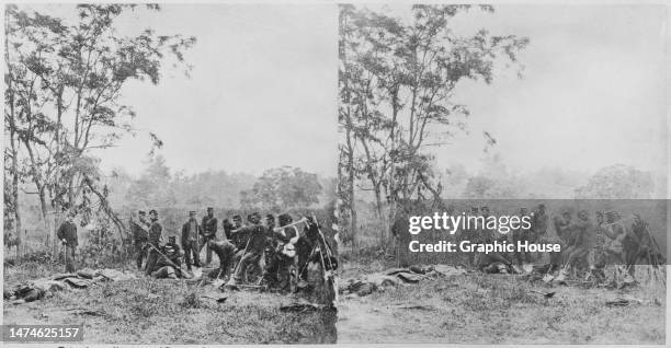Stereoscopic image showing a burial crew of Union soldiers burying the dead on the battlefield, with bodies on the ground to the left of the frame,...