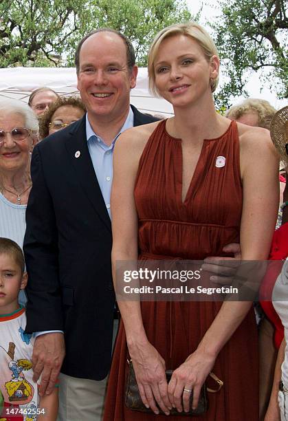 Prince Albert II of Monaco and Princess Charlene attend the annual Monaco Red Cross Pique-Nique at Jardins Princesse Antoinette on June 30, 2012 in...