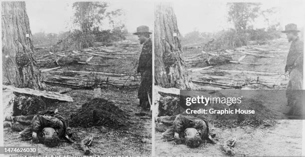 Stereoscopic image showing a Union soldier standing over the body of an unburied Confederate soldier lying on the battlefield where he fell during...