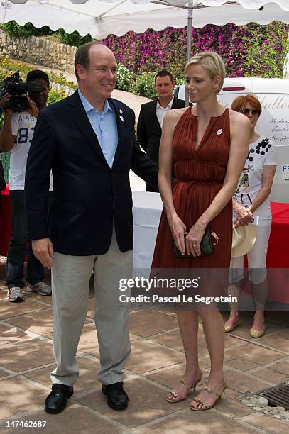 Prince Albert II of Monaco and Princess Charlene attend the annual Monaco Red Cross Pique-Nique at Jardins Princesse Antoinette on June 30, 2012 in...