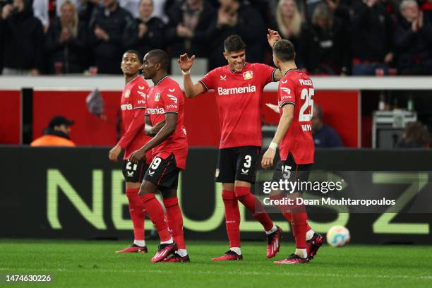 Exequiel Palacios of Bayer 04 Leverkusen celebrates with teammates after scoring the team's first goal during the Bundesliga match between Bayer 04...