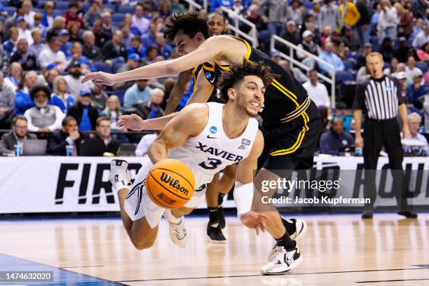 Colby Jones of the Xavier Musketeers is fouled by Guillermo Diaz Graham of the Pittsburgh Panthers during the second half in the second round of the...