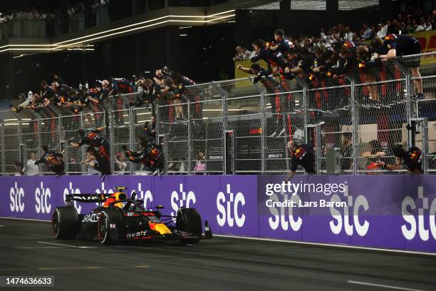 Race winner Sergio Perez of Mexico driving the Oracle Red Bull Racing RB19 passes his team celebrating on the pitwall during the F1 Grand Prix of...