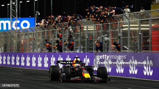 Second placed Max Verstappen of the Netherlands driving the Oracle Red Bull Racing RB19 passes his team celebrating on the pitwall during the F1...