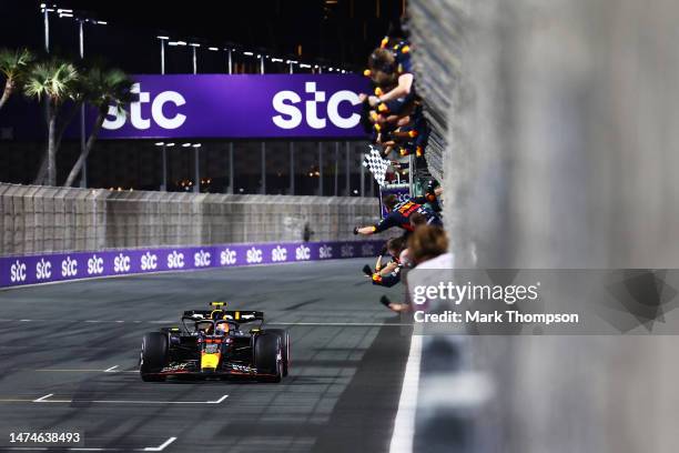 Race winner Sergio Perez of Mexico driving the Oracle Red Bull Racing RB19 passes his team celebrating on the pitwall during the F1 Grand Prix of...