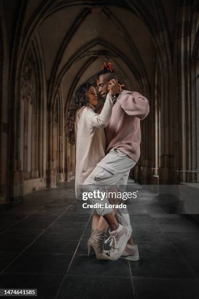 urban mixed race couple dancing in classical public place - bachata stock pictures, royalty-free photos & images
