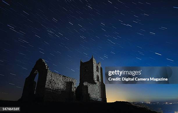 Long exposure of star trails wheeling over a clear night sky above a derelict rural church, taken on October 27, 2011.