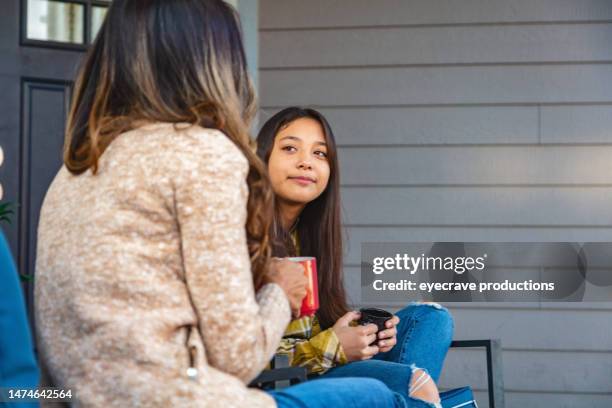 asian mother and multiracial daughter outdoors relaxing and communicating without technology quality time photo series - mother and daughter hugging stock pictures, royalty-free photos & images