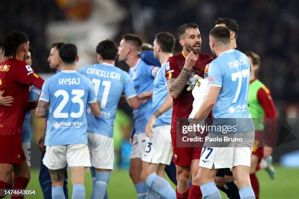 Leonardo Spinazzola of AS Roma speaks with Adam Marusic of SS Lazio during the Serie A match between SS Lazio and AS Roma at Stadio Olimpico on March...