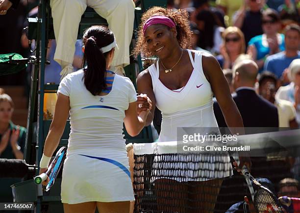 Serena Williams of the USA shakes hands with Jie Zheng of China after defeating her in their Ladies' Singles third round match on day six of the...
