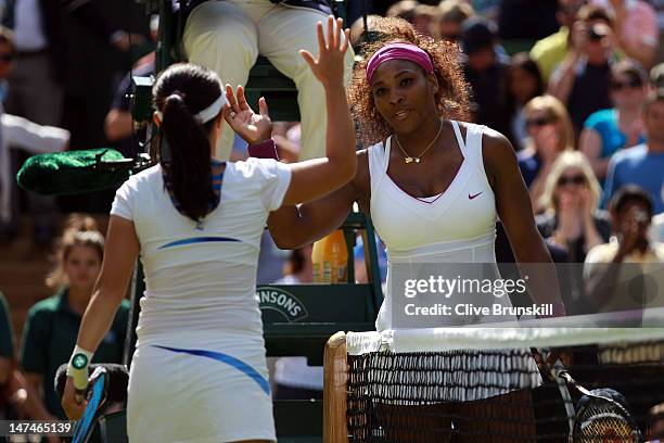 Serena Williams of the USA shakes hands with Jie Zheng of China after defeating her in their Ladies' Singles third round match on day six of the...