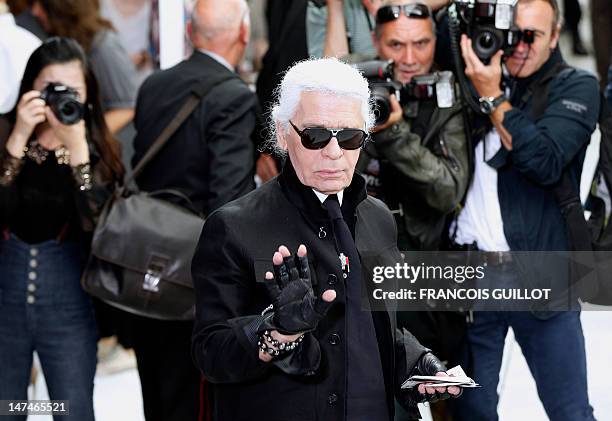 German-born fashion designer Karl Lagerfeld attends the men's spring-summer 2013 fashion collection show of Belgian designer Kris Van Assche for the...