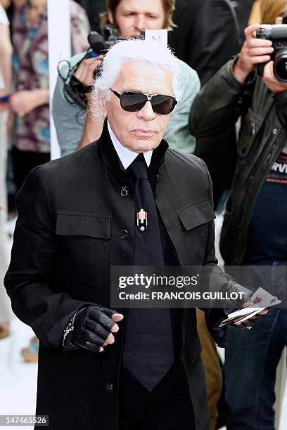 German-born fashion designer Karl Lagerfeld attends the men's spring-summer 2013 fashion collection show of Belgian designer Kris Van Assche for the...