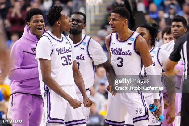 Nae'Qwan Tomlin of the Kansas State Wildcats celebrates with teammates during the first half against the Kentucky Wildcats in the second round of the...