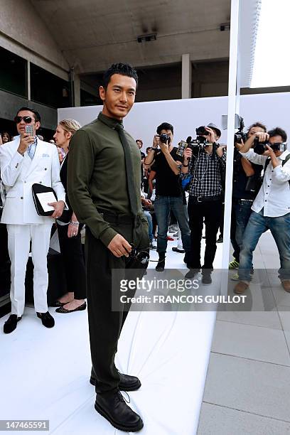 Chinese actor and singer Huang Xiaoming is pictured before the start of the men's spring-summer 2013 fashion collection show of Belgian designer Kris...