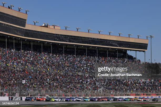 Joey Logano, driver of the Autotrader Ford, leads the field to start the NASCAR Cup Series Ambetter Health 400 at Atlanta Motor Speedway on March 19,...