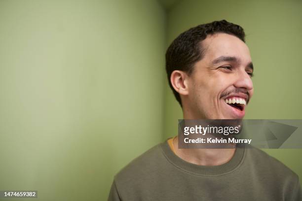 portrait of laughing young man - arab face stock-fotos und bilder
