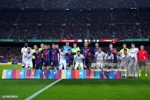 Barcelona and Real Madrid players pose for a photo behind a banner as part of LaLiga Week Against Racism prior to the LaLiga Santander match between...