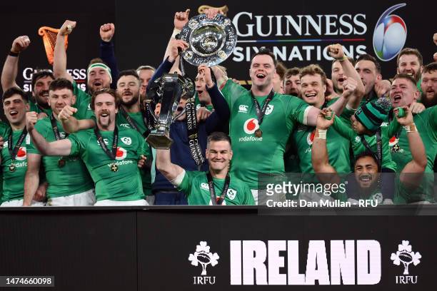 Johnny Sexton of Ireland lifts the Six Nations Trophy as James Bryan of Ireland lifts the Triple Crown Trophy after winning the Six Nations with a...