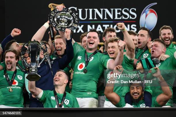 Johnny Sexton of Ireland lifts the Six Nations Trophy as James Bryan of Ireland lifts the Triple Crown Trophy after winning the Six Nations with a...